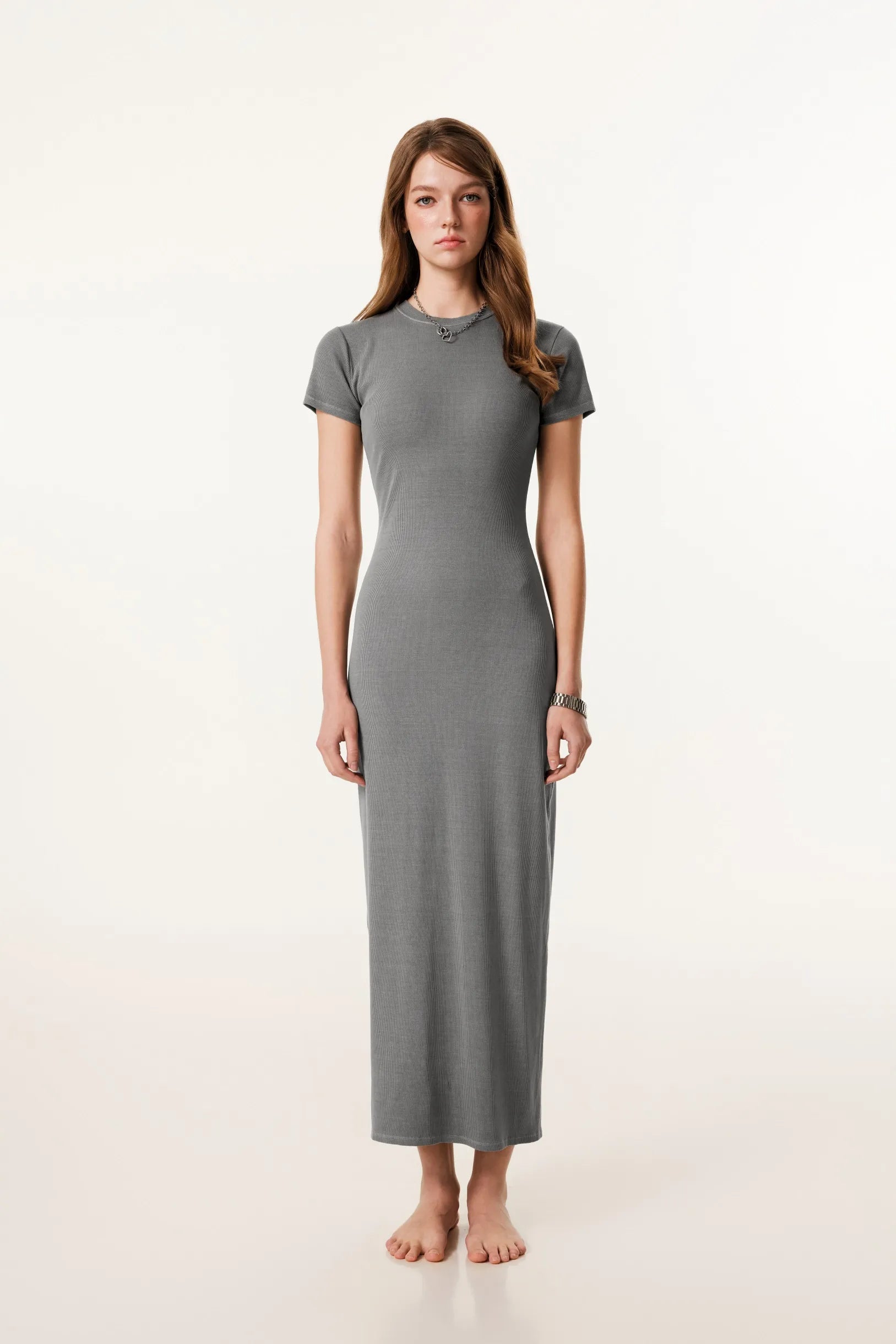 Woman wearing a gray dress on a white background