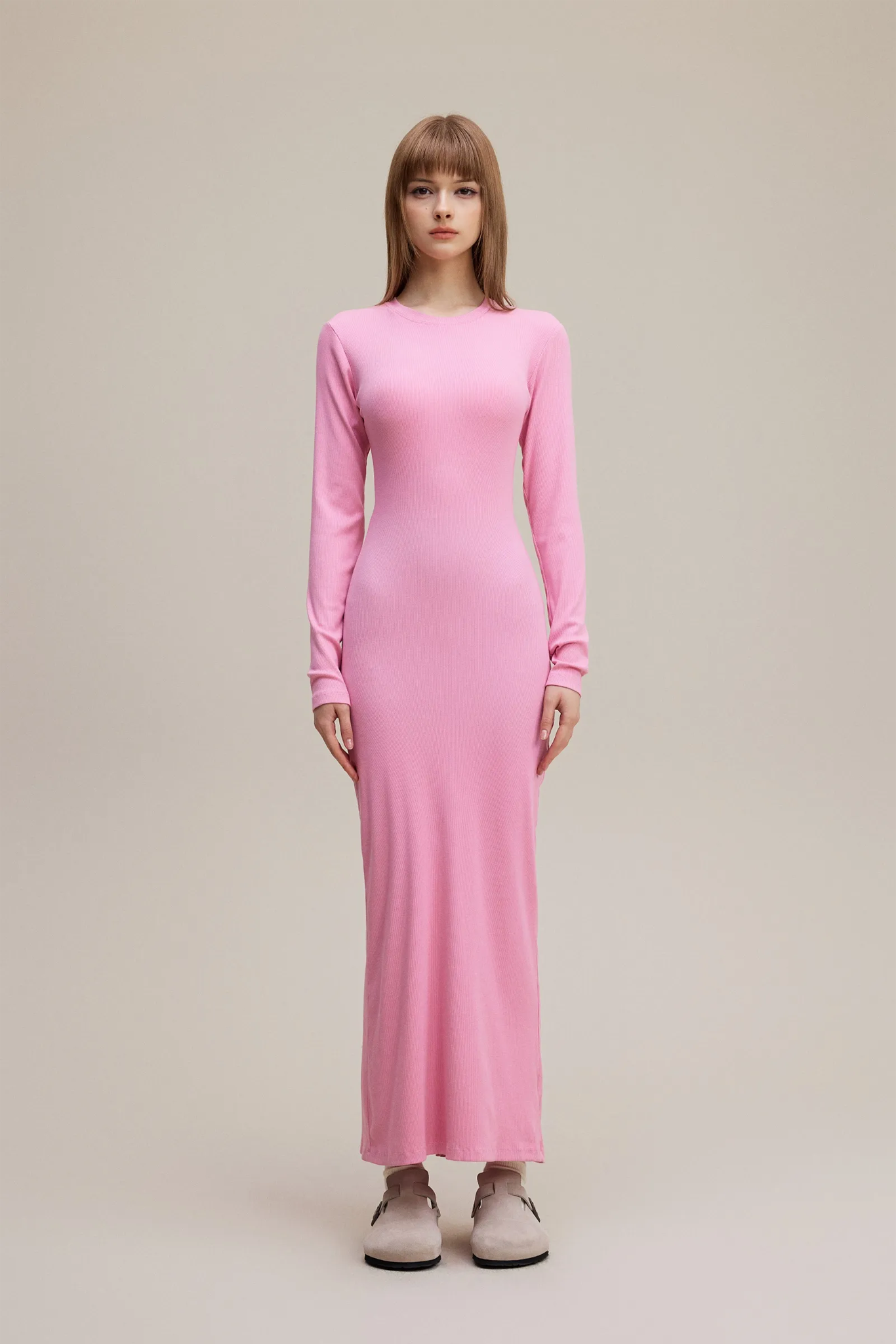 Woman wearing a pink dress on a beige background