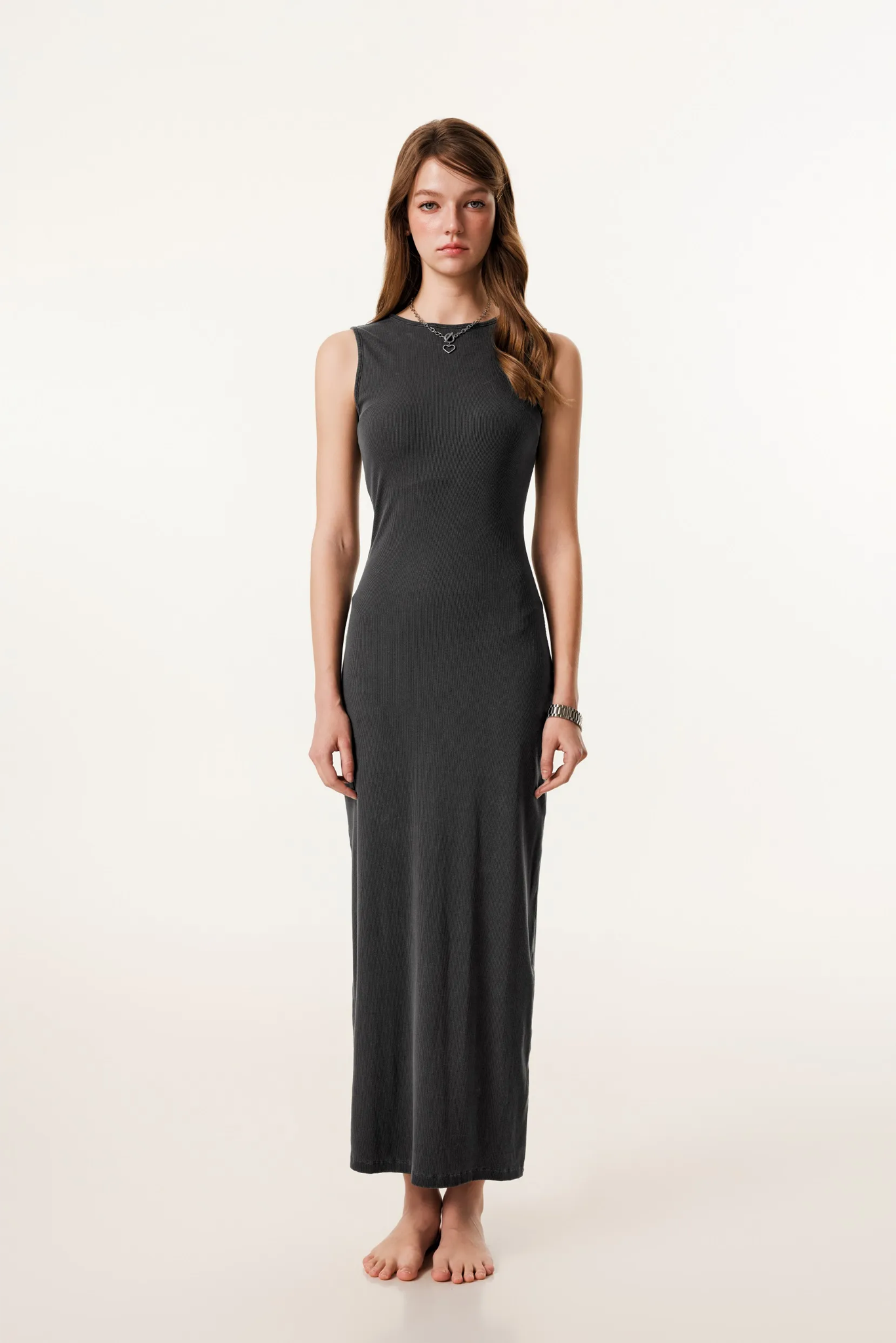 Woman wearing a long black dress on a white background