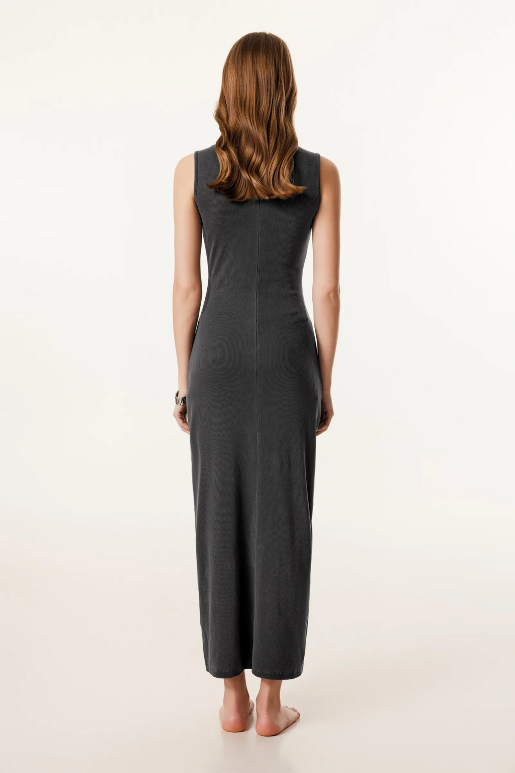 Woman wearing a black sleeveless jumpsuit on a white background