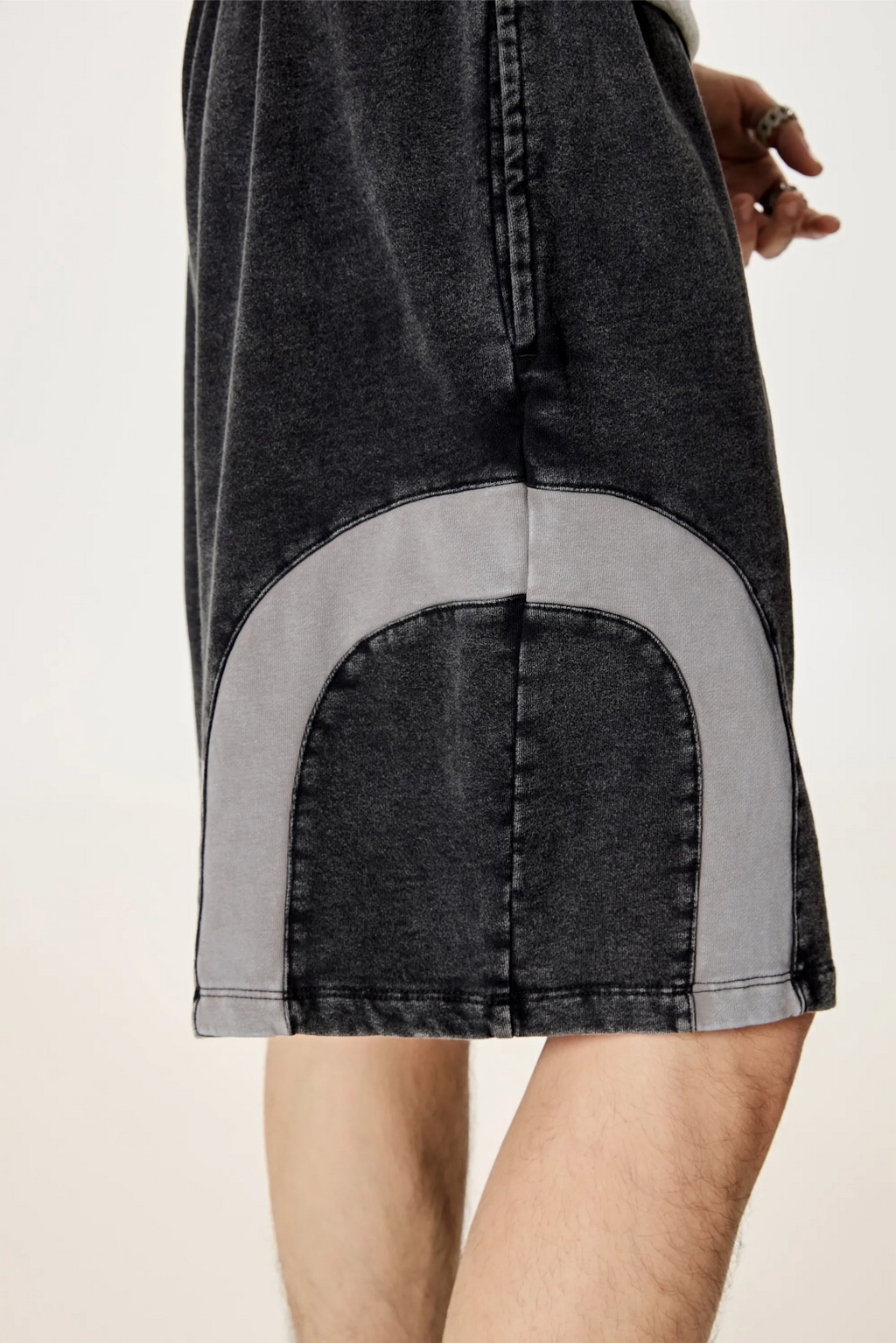 Black denim skirt with gray patch on a plain background