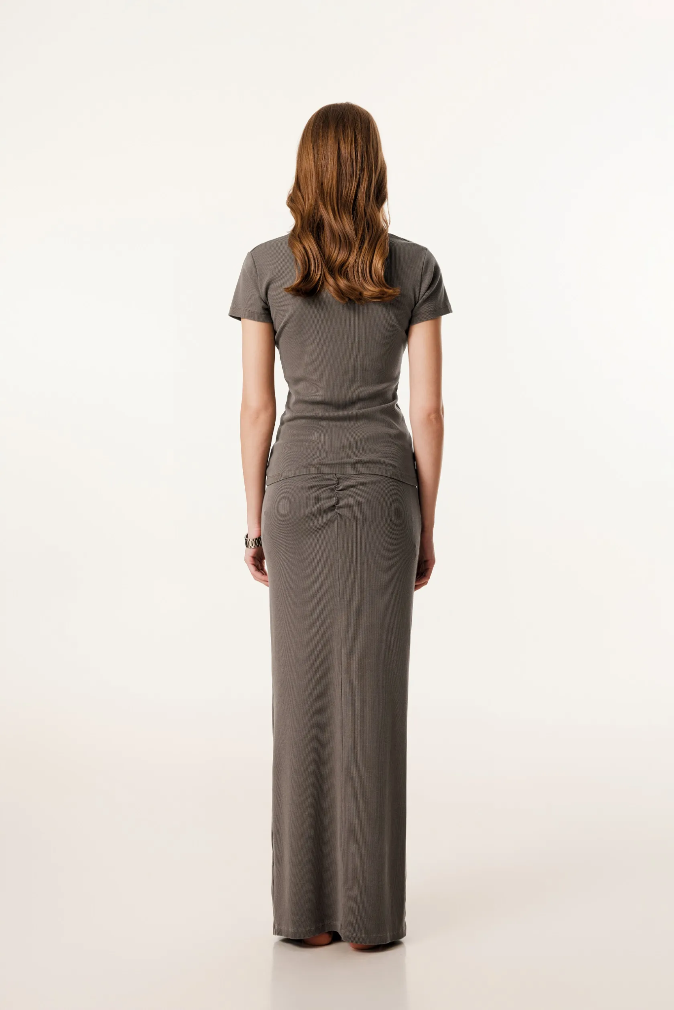 Woman wearing a gray dress on a white background