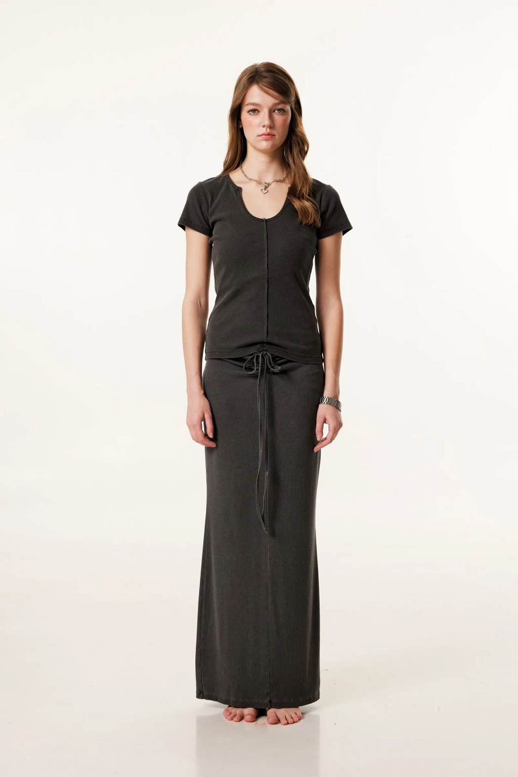 Woman wearing a black outfit on a white background