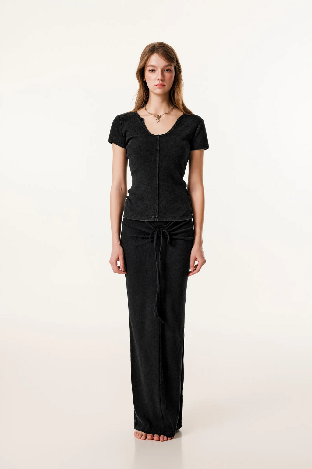 Woman wearing a black outfit on a white background