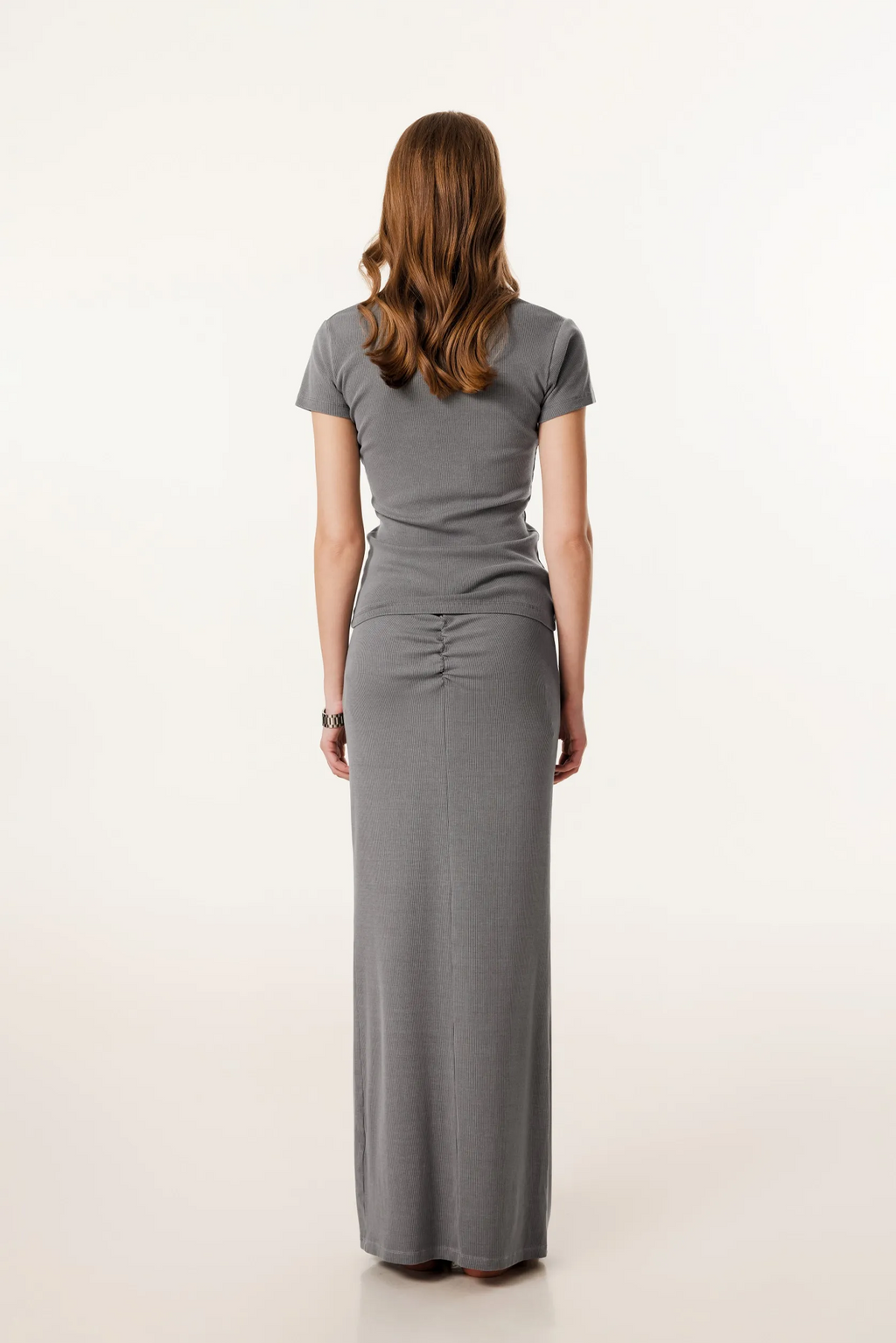 Woman wearing a gray dress on a white background