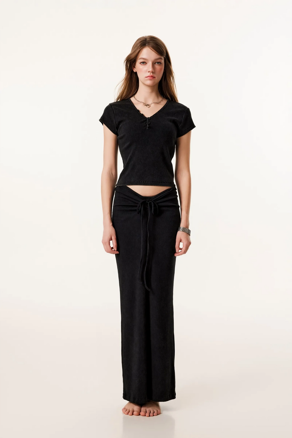 Woman wearing a black outfit on a white background