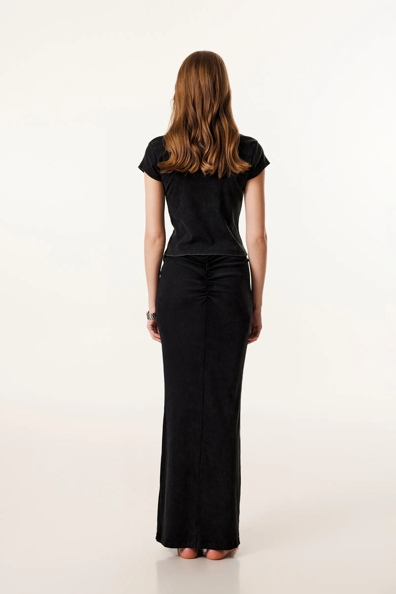 Woman wearing a black dress on a white background