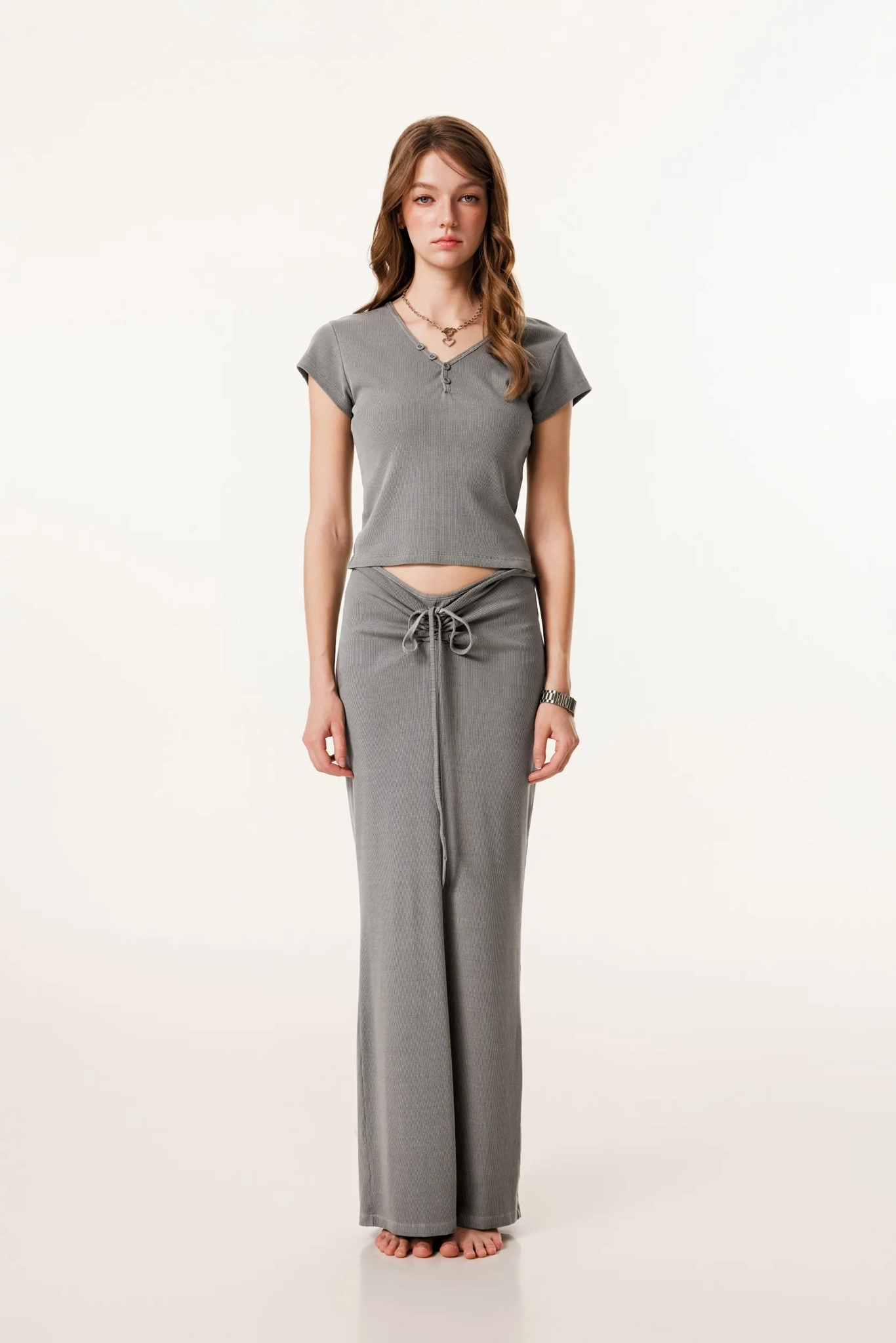 Woman wearing a gray outfit on a white background