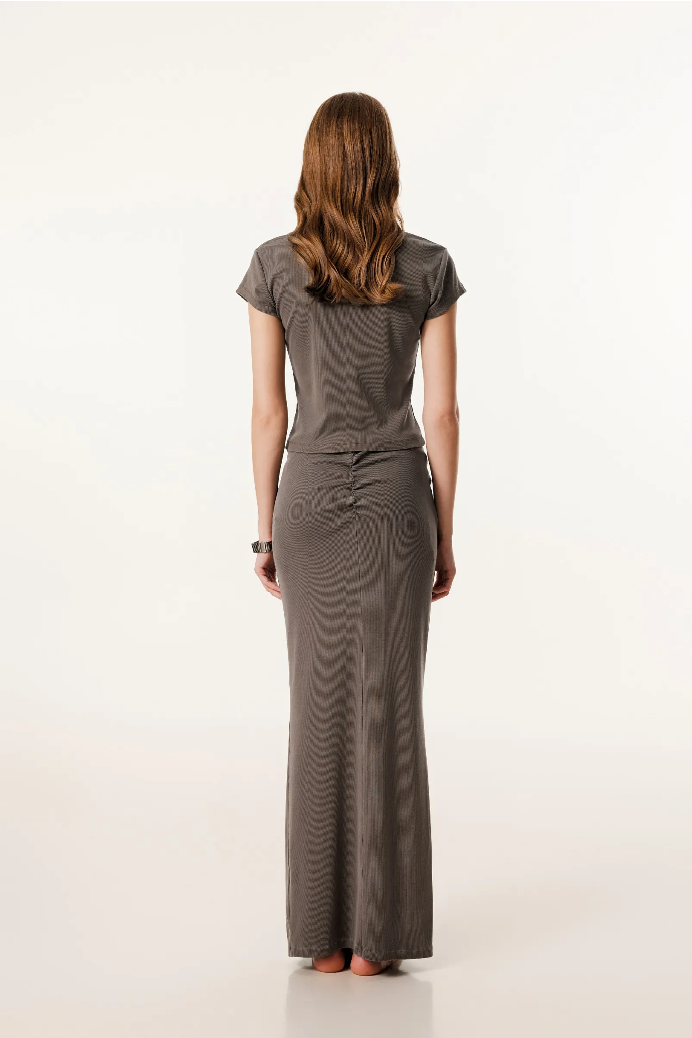 Woman wearing a gray dress on a white background