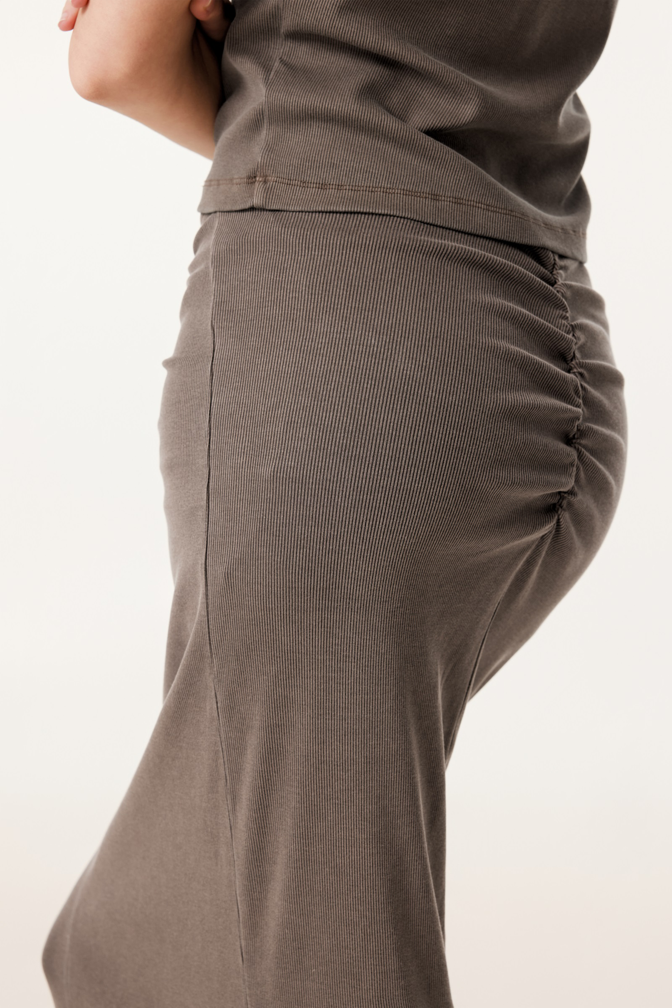 Close-up of brown pants on a plain background
