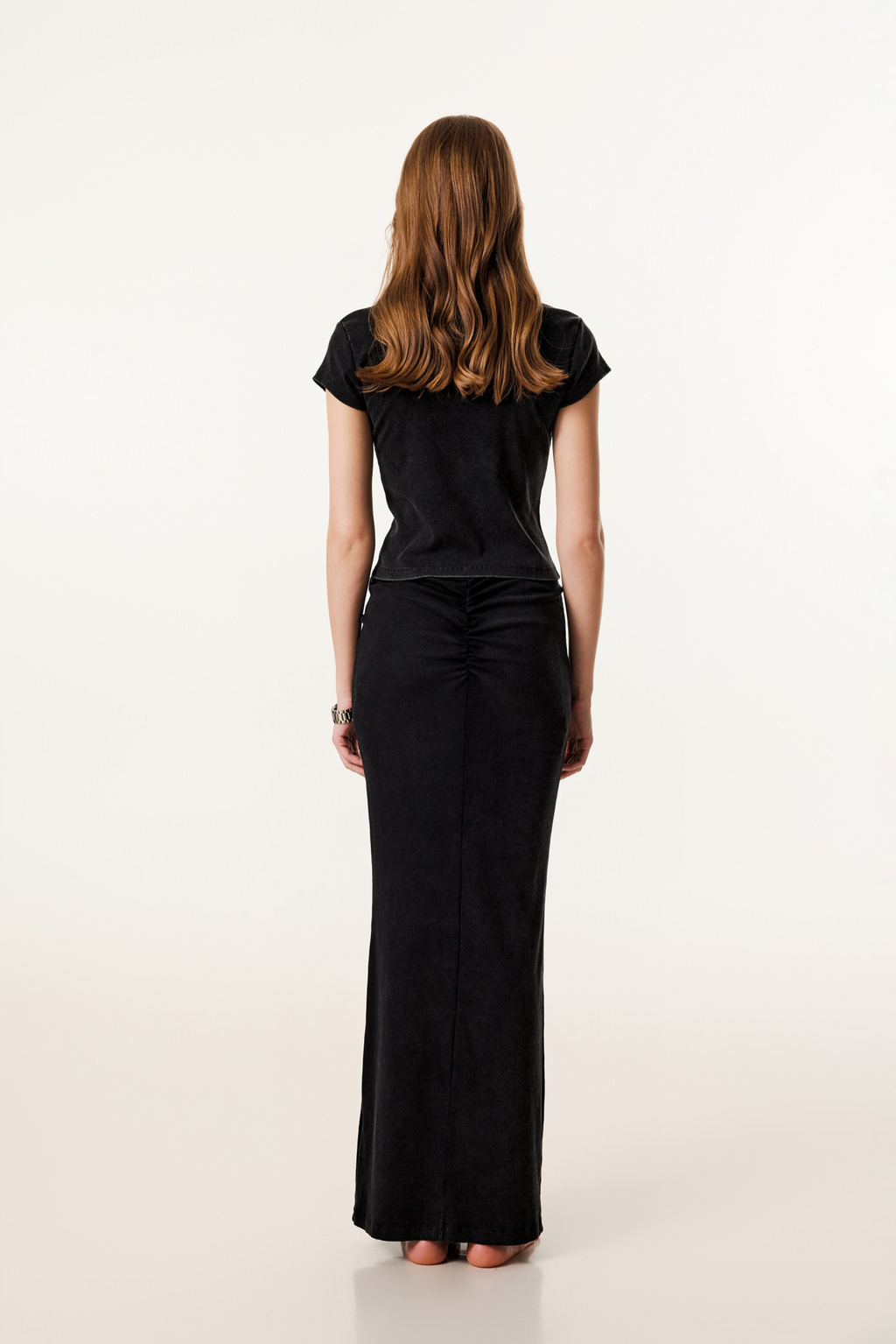 Woman wearing a black dress on a white background