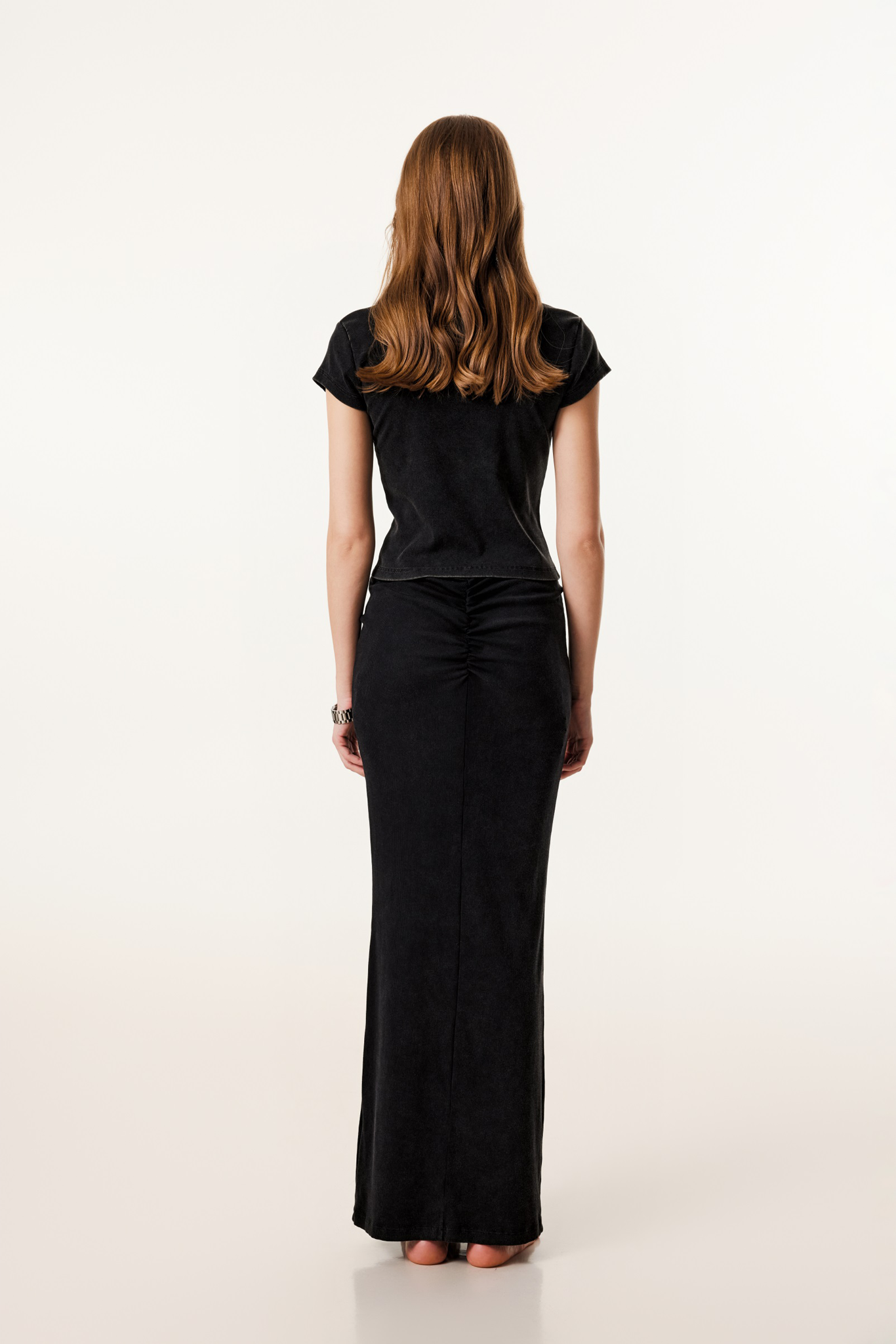 Woman wearing a black dress on a white background