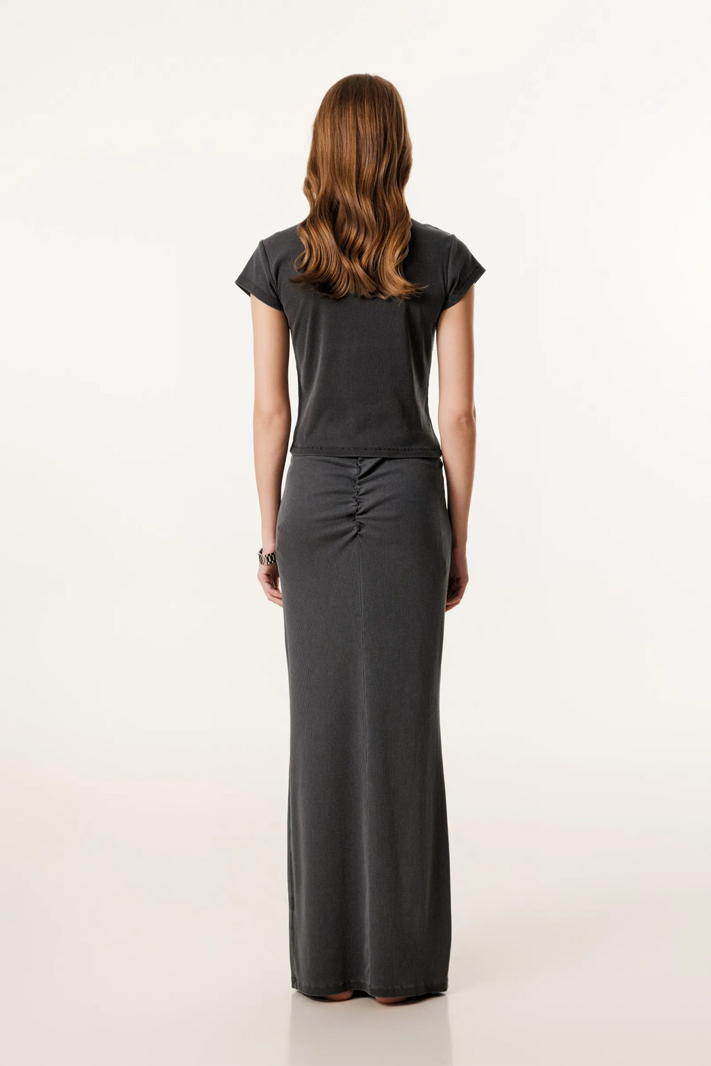 Woman wearing a black dress with a plain white background