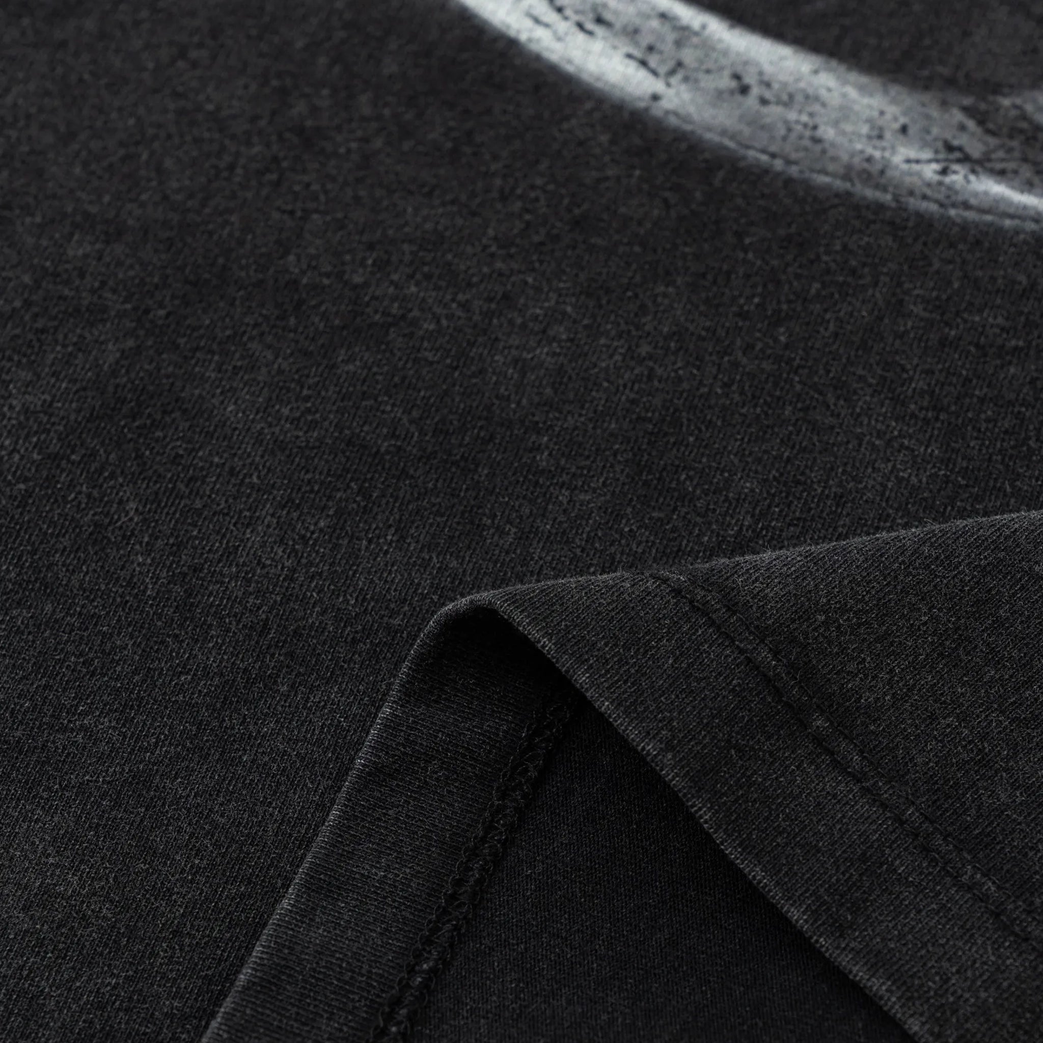 Close-up of dark fabric with a visible seam