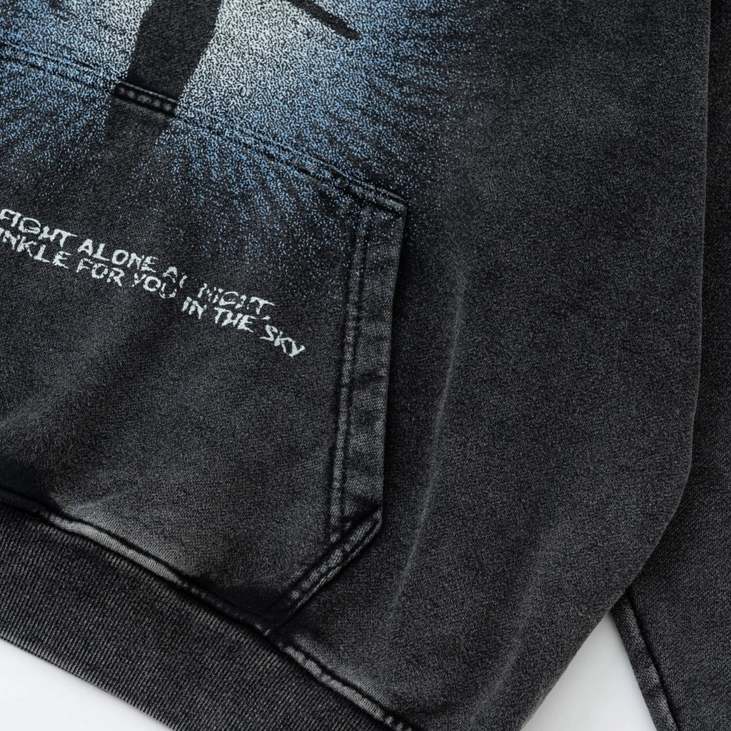 Black denim jacket with embroidered text on a white background