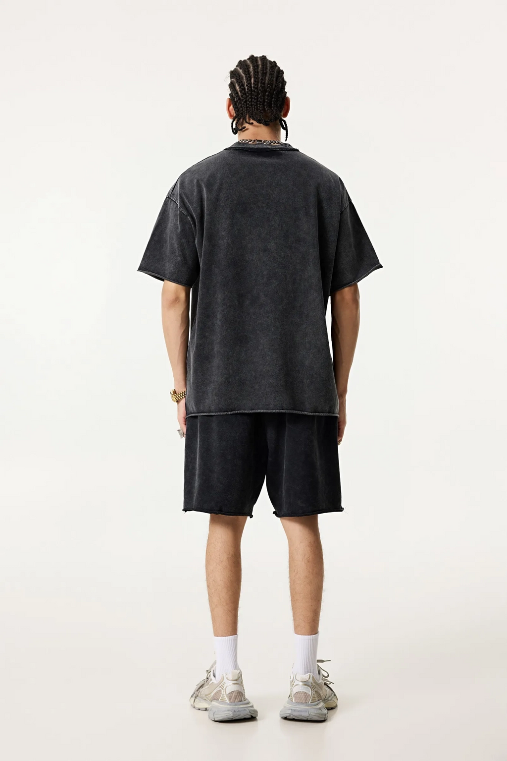 Person wearing a black t-shirt and shorts set on a white background