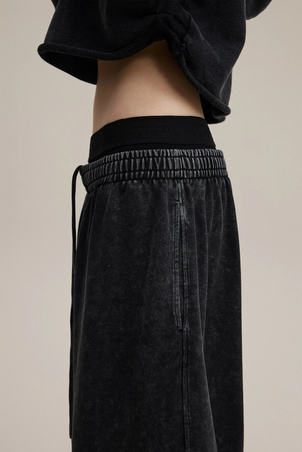 Black pants with a beige background