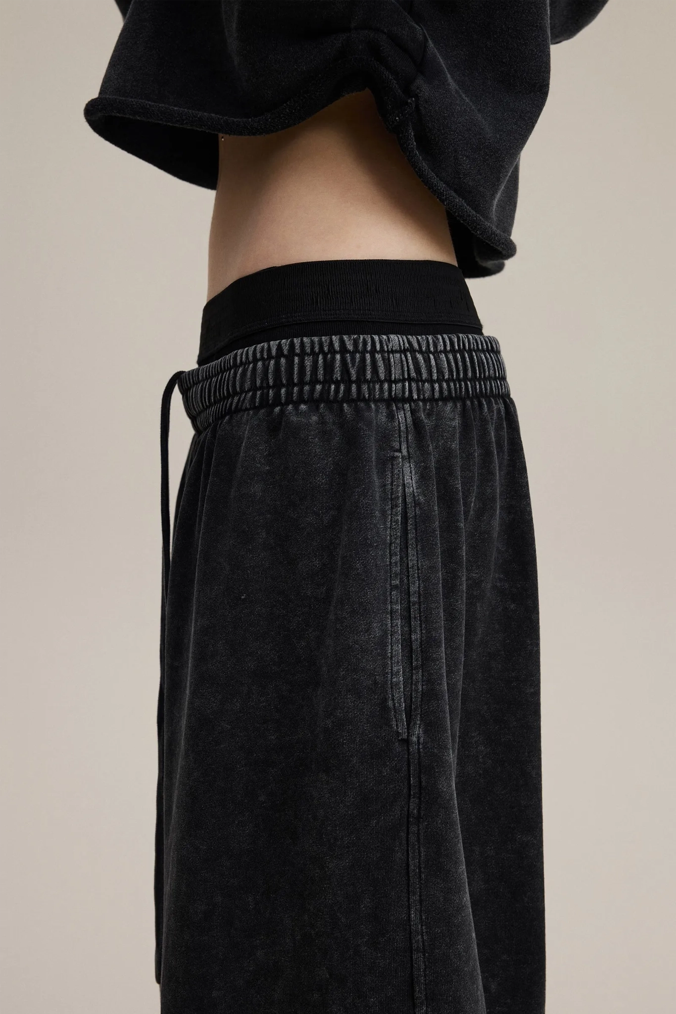 Black pants with a beige background